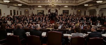 A group of people sitting in a room with cameras