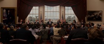 Movie still from “Evan Almighty” (2007), directed by Tom Shadyac – A group of people sitting in front of a large window; Wide shot, Low angle