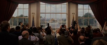 Movie still from “Evan Almighty” (2007), directed by Tom Shadyac – A group of people taking pictures of a building through a window; Extreme Wide shot, Low angle