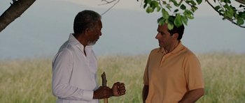 Movie still from “Evan Almighty” (2007), directed by Tom Shadyac – Two men standing next to each other on a field; Medium shot, Over the shoulder angle