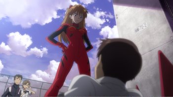 Movie still from “Evangelion: 2.0 You Can (Not) Advance” (2009), directed by Joe Fria – A man looking at a woman in a red suit; Medium shot, Low angle