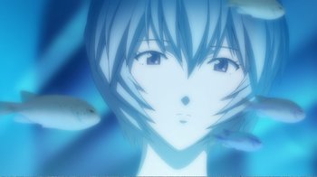 Movie still from “Evangelion: 2.0 You Can (Not) Advance” (2009), directed by Joe Fria – A woman's face with a fish in the background; Extreme Close Up shot, Low angle