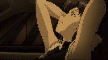 Movie still from “Evangelion: 2.0 You Can (Not) Advance” (2009), directed by Joe Fria – A man sitting in a chair with his hands behind his head; Close Up shot, Low angle