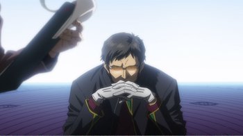 Movie still from “Evangelion: 2.0 You Can (Not) Advance” (2009), directed by Joe Fria – An animated man in a black jacket and white gloves is holding his hands to his face; Close Up shot, Low angle