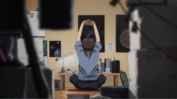 Movie still from “Evangelion: 2.0 You Can (Not) Advance” (2009), directed by Joe Fria – A person sitting on the ground in a room; Wide shot, High angle