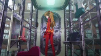 Movie still from “Evangelion: 2.0 You Can (Not) Advance” (2009), directed by Joe Fria – A woman standing in a room with a lot of furniture; Wide shot, Low angle