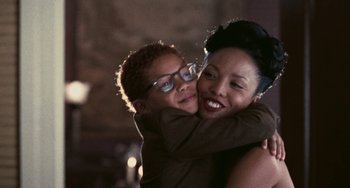 Movie still from “Eve's Bayou” (1997), directed by Kasi Lemmons – A woman and a boy are hugging each other; Close Up shot, Over the shoulder angle