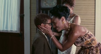 Movie still from “Eve's Bayou” (1997), directed by Kasi Lemmons – A woman touching the face of a young boy; Close Up shot, Over the shoulder angle