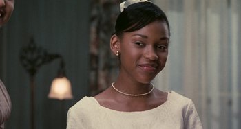 Movie still from “Eve's Bayou” (1997), directed by Kasi Lemmons – A young woman wearing a white dress and a bow in her hair; Close Up shot, Over the shoulder angle
