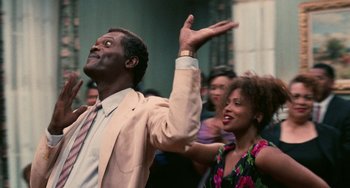 Movie still from “Eve's Bayou” (1997), directed by Kasi Lemmons – A man and a woman are dancing in front of a crowd; Close Up shot, Low angle
