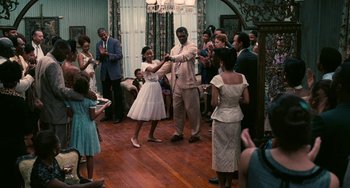 Movie still from “Eve's Bayou” (1997), directed by Kasi Lemmons – A group of people dancing in a living room; Wide shot, High angle