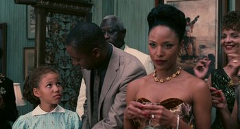 Movie still from “Eve's Bayou” (1997), directed by Kasi Lemmons – A man and a woman standing next to each other in a room; Close Up shot, Over the shoulder angle