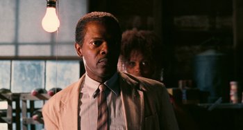 Movie still from “Eve's Bayou” (1997), directed by Kasi Lemmons – A man and a woman standing next to each other in a room; Close Up shot, Over the shoulder angle