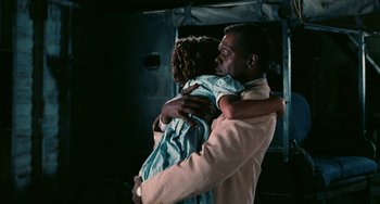 Movie still from “Eve's Bayou” (1997), directed by Kasi Lemmons – A man holding a little girl in his arms; Medium shot, Over the shoulder angle