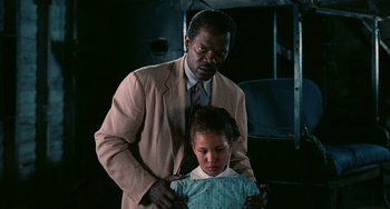 Movie still from “Eve's Bayou” (1997), directed by Kasi Lemmons – A man and a young girl standing next to each other; Medium shot, Low angle