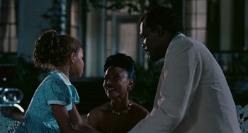 Movie still from “Eve's Bayou” (1997), directed by Kasi Lemmons – Two men and a woman standing next to each other; Medium shot, Over the shoulder angle