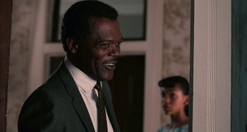 Movie still from “Eve's Bayou” (1997), directed by Kasi Lemmons – A man in a suit and tie next to a woman in a dress; Close Up shot, Over the shoulder angle
