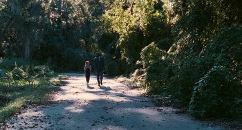 Movie still from “Eve's Bayou” (1997), directed by Kasi Lemmons – A man and a woman walking down a dirt road; Extreme Wide shot, High angle