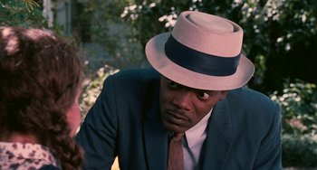 Movie still from “Eve's Bayou” (1997), directed by Kasi Lemmons – A man wearing a hat and a suit is talking to a woman; Close Up shot, Over the shoulder angle
