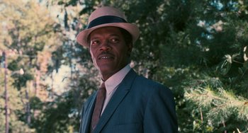 Movie still from “Eve's Bayou” (1997), directed by Kasi Lemmons – A man wearing a suit and a hat in front of a tree; Close Up shot, Over the shoulder angle