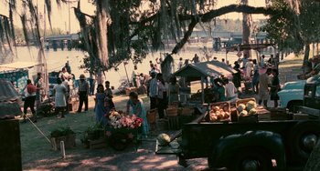 Movie still from “Eve's Bayou” (1997), directed by Kasi Lemmons – A group of people standing around a fruit stand; Extreme Wide shot, High angle