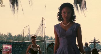 Movie still from “Eve's Bayou” (1997), directed by Kasi Lemmons – Two women in dresses and pearls standing next to each other; Medium shot, Low angle