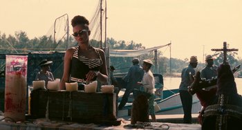 Movie still from “Eve's Bayou” (1997), directed by Kasi Lemmons – A woman standing next to a wooden crate; Medium shot, Over the shoulder angle