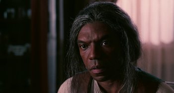 Movie still from “Eve's Bayou” (1997), directed by Kasi Lemmons – A man with long grey hair is looking at the camera; Close Up shot, Over the shoulder angle