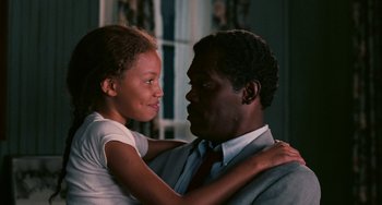 Movie still from “Eve's Bayou” (1997), directed by Kasi Lemmons – A man and a young girl embracing each other in front of a window; Close Up shot, Over the shoulder angle