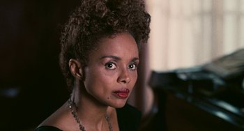 Movie still from “Eve's Bayou” (1997), directed by Kasi Lemmons – A person wearing a black shirt; Close Up shot, Over the shoulder angle