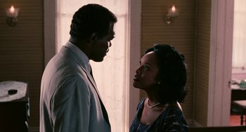 Movie still from “Eve's Bayou” (1997), directed by Kasi Lemmons – A man and a woman standing next to each other in front of a window; Medium shot, Over the shoulder angle