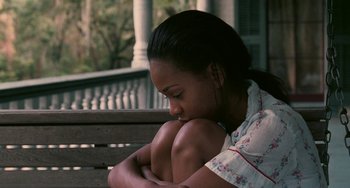 Movie still from “Eve's Bayou” (1997), directed by Kasi Lemmons – A woman sitting on top of a wooden park bench; Medium shot, High angle