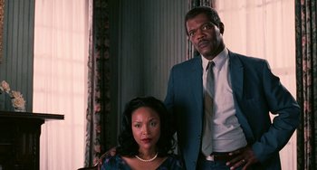 Movie still from “Eve's Bayou” (1997), directed by Kasi Lemmons – A man and a woman posing for a picture; Medium shot, Low angle
