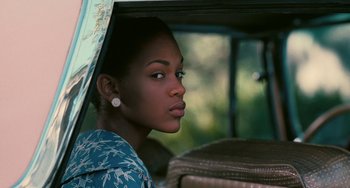Movie still from “Eve's Bayou” (1997), directed by Kasi Lemmons – A woman sitting in the back of a vehicle; Close Up shot, Over the shoulder angle