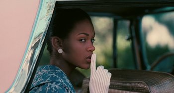 Movie still from “Eve's Bayou” (1997), directed by Kasi Lemmons – A woman with a glove is pointing to her face; Close Up shot, Over the shoulder angle
