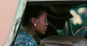 Movie still from “Eve's Bayou” (1997), directed by Kasi Lemmons – A woman sitting in the back seat of a car; Close Up shot, Over the shoulder angle