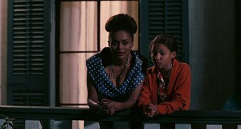Movie still from “Eve's Bayou” (1997), directed by Kasi Lemmons – A woman sitting next to a young girl on top of a bench; Medium shot, Over the shoulder angle
