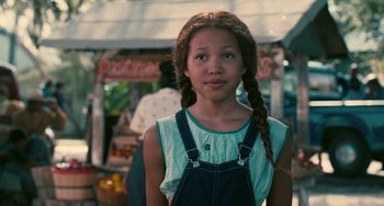 Movie still from “Eve's Bayou” (1997), directed by Kasi Lemmons – A young girl wearing overalls and a blue shirt; Close Up shot, Over the shoulder angle