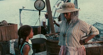 Movie still from “Eve's Bayou” (1997), directed by Kasi Lemmons – An older woman and a young girl stand in front of a scale; Medium shot, Over the shoulder angle
