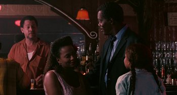 Movie still from “Eve's Bayou” (1997), directed by Kasi Lemmons – A man and a woman talking to each other in a bar; Medium shot, Over the shoulder angle