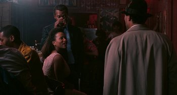 Movie still from “Eve's Bayou” (1997), directed by Kasi Lemmons – A group of people standing around in a room; Medium shot, Over the shoulder angle