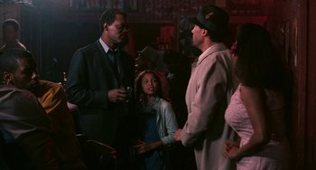 Movie still from “Eve's Bayou” (1997), directed by Kasi Lemmons – Two men and a woman are talking to each other; Medium shot, Over the shoulder angle
