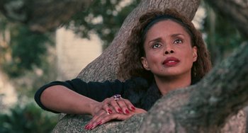 Movie still from “Eve's Bayou” (1997), directed by Kasi Lemmons – A woman leaning up against a large tree; Close Up shot, Low angle