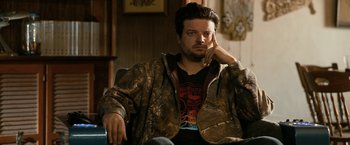 Movie still from “El Camino: A Breaking Bad Movie” (2019), directed by Vince Gilligan – A man sitting in a chair with his hand under his chin; Close Up shot, High angle