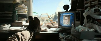 Movie still from “El Camino: A Breaking Bad Movie” (2019), directed by Vince Gilligan – A computer monitor sitting on top of a desk; Wide shot, Low angle