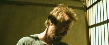 Movie still from “El Camino: A Breaking Bad Movie” (2019), directed by Vince Gilligan – A person with a beard; Close Up shot, Low angle