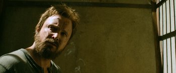 Movie still from “El Camino: A Breaking Bad Movie” (2019), directed by Vince Gilligan – A person smoking a cigarette; Close Up shot, Over the shoulder angle