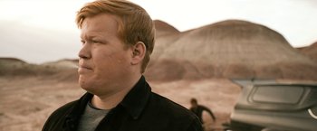 Movie still from “El Camino: A Breaking Bad Movie” (2019), directed by Vince Gilligan – A person wearing a black jacket; Close Up shot, Over the shoulder angle