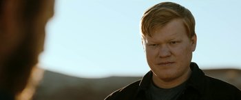 Movie still from “El Camino: A Breaking Bad Movie” (2019), directed by Vince Gilligan – A person wearing a black shirt; Close Up shot, Low angle