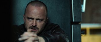 Movie still from “El Camino: A Breaking Bad Movie” (2019), directed by Vince Gilligan – A person wearing a leather jacket; Close Up shot, Low angle